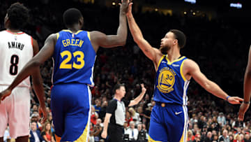 PORTLAND, OREGON - MAY 18: Stephen Curry #30 of the Golden State Warriors high fives Draymond Green #23 during the first half against the Portland Trail Blazers in game three of the NBA Western Conference Finals at Moda Center on May 18, 2019 in Portland, Oregon. NOTE TO USER: User expressly acknowledges and agrees that, by downloading and or using this photograph, User is consenting to the terms and conditions of the Getty Images License Agreement. (Photo by Steve Dykes/Getty Images)