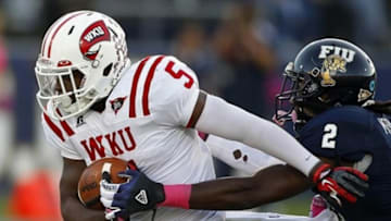 Oct 27 2012; Miami, FL, USA; Western Kentucky Hilltoppers running back Antonio Andrews (5) runs the ball past Florida International Golden Panthers cornerback Junior Mertile (2) in the first quarter at FIU Stadium. Mandatory Credit: Robert Mayer-USA TODAY Sports