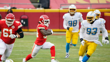Jan 3, 2021; Kansas City, Missouri, USA; Kansas City Chiefs running back Darwin Thompson (34) runs the ball against Los Angeles Chargers defensive tackle Justin Jones (93) during the first half at Arrowhead Stadium. Mandatory Credit: Jay Biggerstaff-USA TODAY Sports