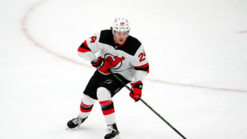 New Jersey Devils defenseman Ty Smith (24) skates the puck against the Arizona Coyotes during the third period at Gila River Arena. Mandatory Credit: Joe Camporeale-USA TODAY Sports