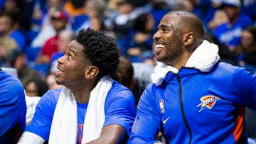 Shai Gilgeous-Alexander #2 and Chris Paul #3 of the OKC Thunder smile during a game against the Dallas Mavericks (Photo by Zach Beeker/NBAE via Getty Images)