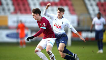 DAGENHAM, ENGLAND - JANUARY 13: Alfie Lewis of West Ham is tackled by Jamie Bowden of Tottenham during the Premier League 2 match between West Ham United and Tottenham Hotspur at Chigwell Construction Stadium on January 13, 2019 in Dagenham, England. (Photo by Alex Pantling/Getty Images)