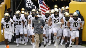 CHARLOTTE, NORTH CAROLINA - DECEMBER 30: Head coach Dave Clawson of the Wake Forest Demon Deacons leads his team onto the field prior to their game against the Wisconsin Badgers in the Duke's Mayo Bowl at Bank of America Stadium on December 30, 2020 in Charlotte, North Carolina. (Photo by Jared C. Tilton/Getty Images)