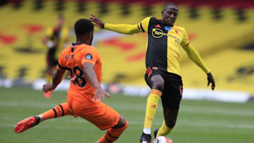 Newcastle United's English defender Danny Rose (L) vies with Watford's French midfielder Abdoulaye Doucoure during the English Premier League football match between Watford and Newcastle at Vicarage Road Stadium in Watford, north of London on July 11, 2020. (Photo by MIKE EGERTON / POOL / AFP) / RESTRICTED TO EDITORIAL USE. No use with unauthorized audio, video, data, fixture lists, club/league logos or 'live' services. Online in-match use limited to 120 images. An additional 40 images may be used in extra time. No video emulation. Social media in-match use limited to 120 images. An additional 40 images may be used in extra time. No use in betting publications, games or single club/league/player publications. / (Photo by MIKE EGERTON/POOL/AFP via Getty Images)