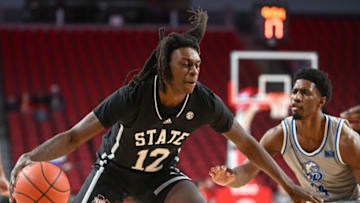 Dec 20, 2022; Lincoln, Nebraska, USA; Mississippi State Bulldogs forward KeShawn Murphy (12) drives against Drake Bulldogs guard Sardaar Calhoun (14) in the first half at Pinnacle Bank Arena. Mandatory Credit: Steven Branscombe-USA TODAY Sports