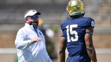 May 1, 2021; Notre Dame, Indiana, USA; Notre Dame Fighting Irish head coach Brian Kelly talks to wide receiver Jordan Johnson (15) in the first half of the Blue-Gold Game at Notre Dame Stadium. Mandatory Credit: Matt Cashore-USA TODAY Sports