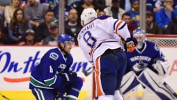 Oct 18, 2015; Vancouver, British Columbia, CAN; Vancouver Canucks defenseman Christopher Tanev (8) blocks a shot by Edmonton Oilers defenseman Griffin Reinhart (8) during the second period at Rogers Arena. Mandatory Credit: Anne-Marie Sorvin-USA TODAY Sports