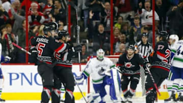 Jan 15, 2016; Raleigh, NC, USA; Carolina Hurricanes defensemen John-Michael Liles (26)] celebrates his third period goal with teammate forward Andrej Nestrasil (15) against the Vancouver Canucks at PNC Arena. The Vancouver Canucks defeated the Carolina Hurricanes 3-2 in overtime. Mandatory Credit: James Guillory-USA TODAY Sports