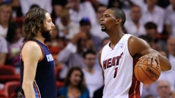 Apr 23, 2014; Miami, FL, USA; Miami Heat center Chris Bosh (right) looks over at Charlotte Bobcats forward Josh McRoberts (11) in game two during the first round of the 2014 NBA Playoffs at American Airlines Arena. Mandatory Credit: Steve Mitchell-USA TODAY Sports