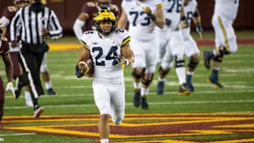 Michigan Wolverines running back Zach Charbonnet (24) rushes with the ball for a touchdown in the first quarter against the Minnesota Golden Gophers at TCF Bank Stadium. Mandatory Credit: Jesse Johnson-USA TODAY Sports