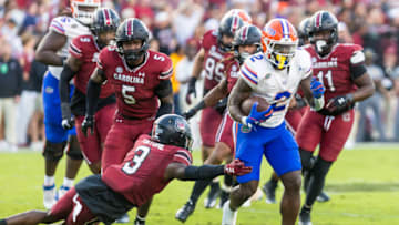 South Carolina football's O'Donnell Fortune struggling to try to tackle Florida's Montrell Johnson. Mandatory Credit: Jeff Blake-USA TODAY Sports
