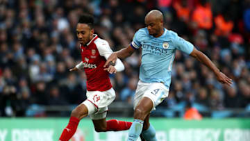 LONDON, ENGLAND - FEBRUARY 25: Pierre-Emerick Aubameyang of Arsenal and Vincent Kompany of Manchester City compete for the ball during the Carabao Cup Final between Arsenal and Manchester City at Wembley Stadium on February 25, 2018 in London, England. (Photo by Catherine Ivill/Getty Images)