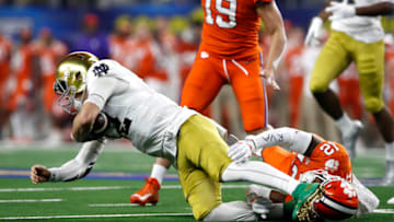 ARLINGTON, TEXAS - DECEMBER 29: K'Von Wallace #12 of the Clemson Tigers tackles Ian Book #12 of the Notre Dame Fighting Irish in the first half during the College Football Playoff Semifinal Goodyear Cotton Bowl Classic at AT&T Stadium on December 29, 2018 in Arlington, Texas. (Photo by Tim Warner/Getty Images)