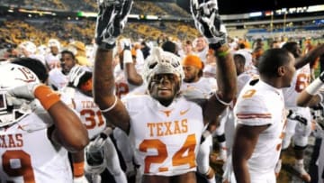 Nov 9, 2013; Morgantown, WV, USA; Texas Longhorns running back Joe Bergeron (24) celebrates after beating the West Virginia Mountaineers 47-40 in overtime at Milan Puskar Stadium. Mandatory Credit: Evan Habeeb-USA TODAY Sports