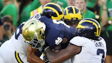 SOUTH BEND, IN - SEPTEMBER 01: Jafar Armstrong #8 of the Notre Dame Fighting Irish carries the ball against Brandon Watson #28 and Rashan Gary #3 of the Michigan Wolverines in the first quarter at Notre Dame Stadium on September 1, 2018 in South Bend, Indiana. (Photo by Gregory Shamus/Getty Images)