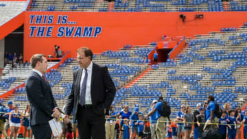 Auburn football offensive coordinator Kenny Dillingham and head coach Gus Malzahn chat on the field before taking on Florida at Ben Hill Griffin Stadium in Gainesville, Fla.., on Saturday, Oct. 5, 2019.
