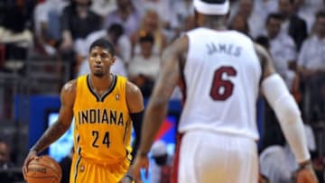 May 30, 2014; Miami, FL, USA; Indiana Pacers forward Paul George (24) dribbles as Miami Heat forward LeBron James (6) defend in game six of the Eastern Conference Finals of the 2014 NBA Playoffs at American Airlines Arena. Mandatory Credit: Steve Mitchell-USA TODAY Sports