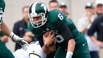 EAST LANSING, MI - OCTOBER 29: Damion Terry #6 of the Michigan State Spartans battles for extra yards while playing the Michigan Wolverines at Spartan Stadium on October 29, 2016 in East Lansing, Michigan. Michigan won the game 32-23. (Photo by Gregory Shamus/Getty Images)