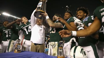 SAN DIEGO, CA - DECEMBER 28: Head coach Mark Dantonio holds up the winning trophy along with players Chris Frey #23, Brian Lewerke #14, and Damion Terry #6 of the Michigan State Spartans after defeating the Washington State Cougars 42-17 in the SDCCU Holiday Bowl at SDCCU Stadium on December 28, 2017 in San Diego, California. (Photo by Sean M. Haffey/Getty Images)