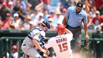 WASHINGTON, DC - JULY 28: Will Smith #16 of the Los Angeles Dodgers tags out Matt Adams #15 of the Washington Nationals trying to score in the second inning during a baseball game at Nationals Park on July 28, 2019 in Washington, DC. (Photo by Mitchell Layton/Getty Images)