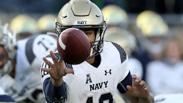 SOUTH BEND, INDIANA - NOVEMBER 16: Malcolm Perry #10 of the Navy Midshipmen tosses the ball in the third quarter against the Wisconsin Badgers at Notre Dame Stadium on November 16, 2019 in South Bend, Indiana. (Photo by Dylan Buell/Getty Images)