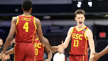 INDIANAPOLIS, INDIANA - MARCH 22: Drew Peterson #13 and Evan Mobley #4 of the USC Trojans react in the first half of their second round game against the Kansas Jayhawks in the 2021 NCAA Men's Basketball Tournament at Hinkle Fieldhouse on March 22, 2021 in Indianapolis, Indiana. (Photo by Andy Lyons/Getty Images)