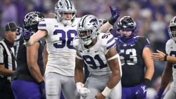 Dec 3, 2022; Arlington, TX, USA; Kansas State Wildcats defensive end Felix Anudike-Uzomah (91) and defensive end Brendan Mott (38) celebrate after Anudike-Uzomah sacks TCU Horned Frogs quarterback Max Duggan (15) during the second half at AT&T Stadium. Mandatory Credit: Jerome Miron-USA TODAY Sports