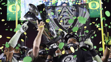 LOS ANGELES, CALIFORNIA - DECEMBER 18: Head coach Mario Cristobal hoists the trophy, with most valuable player, Kayvon Thibodeaux #5 of the Oregon Ducks, in celebration a 31-24 win over the USC Trojans during the PAC 12 2020 Football Championship at United Airlines Field at the Coliseum on December 18, 2020 in Los Angeles, California. (Photo by Harry How/Getty Images)