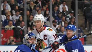 Frederik Andersen #31 of the Toronto Maple Leafs keeps an eye on a puck with Jonathan Toews #19 of the Chicago Blackhawks on his doorstep during an NHL game at Scotiabank Arena. (Photo by Claus Andersen/Getty Images)
