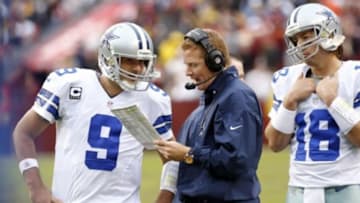 Dec 22, 2013; Landover, MD, USA; Dallas Cowboys quarterback Tony Romo (9) talks with Cowboys head coach Jason Garrett (R) during a timeout against the Washington Redskins in the fourth quarter at FedEx Field. The Cowboys won 24-23. Mandatory Credit: Geoff Burke-USA TODAY Sports