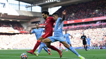 Liverpool's midfielder Mohamed Salah and Manchester City's defender Joao Cancelo (Photo by PAUL ELLIS/AFP via Getty Images)