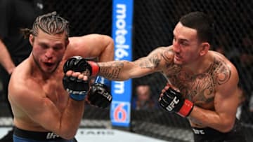 TORONTO, CANADA - DECEMBER 08: (R-L) Max Holloway punches Brian Ortega in their UFC featherweight championship fight during the UFC 231 event at Scotiabank Arena on December 8, 2018 in Toronto, Canada. (Photo by Josh Hedges/Zuffa LLC/Zuffa LLC via Getty Images)