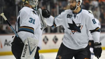 October 26, 2014; Anaheim, CA, USA; San Jose Sharks goalie Antti Niemi (31) and defenseman Brent Burns (88) celebrate the 4-1 victory against the Anaheim Ducks during the third period at Honda Center. Mandatory Credit: Gary A. Vasquez-USA TODAY Sports