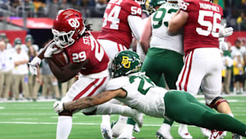 Dec 7, 2019; Arlington, TX, USA; Oklahoma Sooner running back Rhamondre Stevenson (29) runs with the ball for an overtime touchdown against Baylor Bears linebacker Terrel Bernard (26) in the 2019 Big 12 Championship Game at AT&T Stadium. Mandatory Credit: Matthew Emmons-USA TODAY Sports
