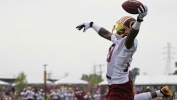 Aug 6, 2013; Richmond, VA, USA; Washington Redskins wide receiver Dezmon Briscoe (19) leaps to catch the ball during afternoon practice as part of the 2013 NFL training camp at the Bon Secours Washington Redskins Training Center. Mandatory Credit: Geoff Burke-USA TODAY Sports