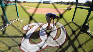 Feb 23, 2016; Viera, FL, USA; A grounds keeper spray paints a Washington Nationals logo during a work out at Space Coast Stadium. Mandatory Credit: Logan Bowles-USA TODAY Sports