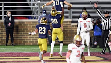 Nov 14, 2020; Chestnut Hill, Massachusetts, USA; Notre Dame Fighting Irish wide receiver Ben Skowronek (11) is lifted by wide receiver Javon McKinley (88) after scoring a touchdown against the Boston College Eagles during the first half at Alumni Stadium. Mandatory Credit: Brian Fluharty-USA TODAY Sports
