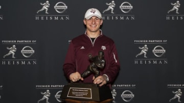 NEW YORK, NY - DECEMBER 13: 2013 Heisman Trophy finalist Johnny Manziel, quarterback of the Texas A&M University Aggies, poses with the Heisman Trophy at the Marriott Marquis on December 13, 2013 in New York City. NOTE TO USER: Photographer approval needed for all Commercial License requests. (Photo by Kelly Kline/Getty Images for The Heisman)