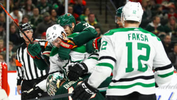 ST. PAUL, MN - MARCH 29: Dallas Stars left wing Antoine Roussel (21) is grabbed by Minnesota Wild left wing Marcus Foligno (17) during the Western Conference game between the Dallas Stars and the Minnesota Wild on March 29, 2018 at Xcel Energy Center in St. Paul, Minnesota. The Wild defeated the Stars 5-2. (Photo by David Berding/Icon Sportswire via Getty Images)