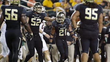Sep 24, 2016; Waco, TX, USA; Baylor Bears defensive end Greg Roberts (52) pats defensive back Patrick Levels (21) on the helmet after a tackle for loss against the Oklahoma State Cowboys during the second half at McLane Stadium. Baylor won 35-24. Mandatory Credit: Ray Carlin-USA TODAY Sports