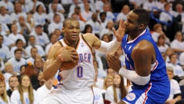 May 13, 2014; Oklahoma City, OK, USA; Oklahoma City Thunder guard Russell Westbrook (0) handles the ball against Los Angeles Clippers forward Glen Davis (0) during the fourth quarter in game five of the second round of the 2014 NBA Playoffs at Chesapeake Energy Arena. Mandatory Credit: Mark D. Smith-USA TODAY Sports