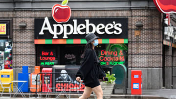 NEW YORK, NEW YORK - AUGUST 16: A person wears a protective face mask outside of Applebee’s restaurant in Times Square as the city continues Phase 4 of re-opening following restrictions imposed to slow the spread of coronavirus on August 16, 2020 in New York City. The fourth phase allows outdoor arts and entertainment, sporting events without fans and media production. (Photo by Noam Galai/Getty Images)
