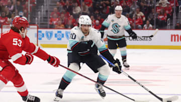 DETROIT, MICHIGAN - OCTOBER 24: Matty Beniers #10 of the Seattle Kraken tries to get around the stick of Moritz Seider #53 of the Detroit Red Wings during the first period at Little Caesars Arena on October 24, 2023 in Detroit, Michigan. (Photo by Gregory Shamus/Getty Images)