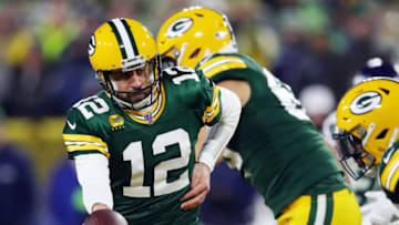 GREEN BAY, WISCONSIN - JANUARY 12: Aaron Rodgers #12 of the Green Bay Packers looks to hand off the ball during the first half against the Seattle Seahawks in the NFC Divisional Playoff game at Lambeau Field on January 12, 2020 in Green Bay, Wisconsin. (Photo by Gregory Shamus/Getty Images)
