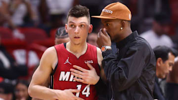 Tyler Herro #14 and Jimmy Butler #22 of the Miami Heat talk against the Atlanta Hawks (Photo by Michael Reaves/Getty Images)