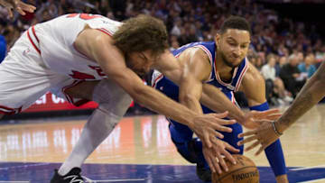 PHILADELPHIA, PA - OCTOBER 18: Robin Lopez #42 of the Chicago Bulls Ben Simmons #25 of the Philadelphia 76ers dive for the ball in the third quarter at Wells Fargo Center on October 18, 2018 in Philadelphia, Pennsylvania. The 76ers defeated the Bulls 127-108. NOTE TO USER: User expressly acknowledges and agrees that, by downloading and or using this photograph, User is consenting to the terms and conditions of the Getty Images License Agreement. (Photo by Mitchell Leff/Getty Images)