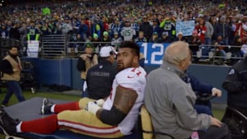 Jan 19, 2014; Seattle, WA, USA; San Francisco 49ers guard Mike Iupati (77) is carted off the field during the first half of the 2013 NFC Championship football game against the Seattle Seahawks at CenturyLink Field. Mandatory Credit: Kirby Lee-USA TODAY Sports