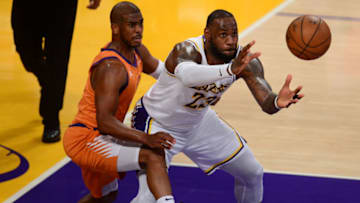 Former OKC Thunder players feast in playoffs - LeBron James (23) gets the ball against the defense of Phoenix Suns guard Chris Paul (3) : Gary A. Vasquez-USA TODAY Sports