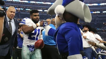 Dec 18, 2016; Arlington, TX, USA; Dallas Cowboys running back Ezekiel Elliott (21) celebrates with mascot Rowdy after the game against the Tampa Bay Buccaneers at AT&T Stadium. Dallas beat Tampa 26-20. Mandatory Credit: Matthew Emmons-USA TODAY Sports