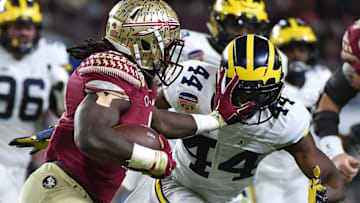 Dec 30, 2016; Miami Gardens, FL, USA; Florida State Seminoles running back Dalvin Cook (4) runs the ball against Michigan Wolverines safety Delano Hill (44) during the first half at Hard Rock Stadium. Mandatory Credit: Jasen Vinlove-USA TODAY Sports